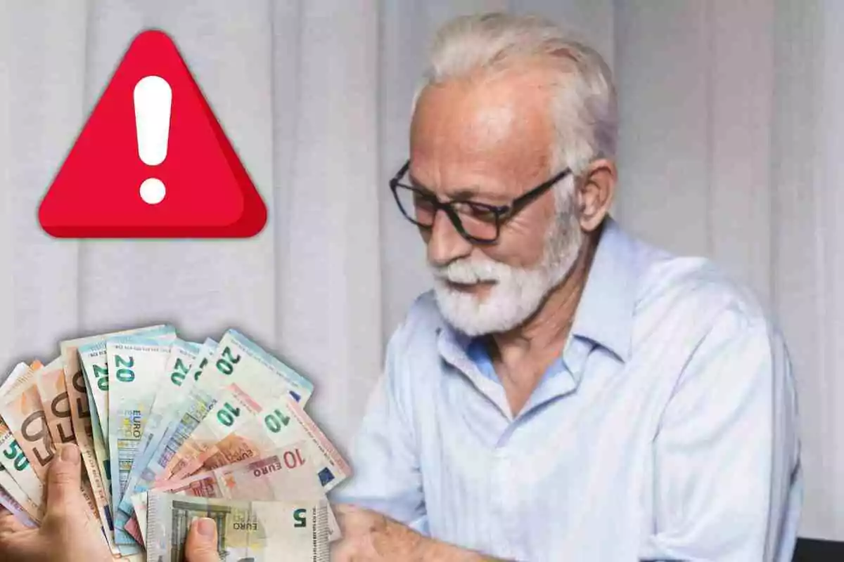 Un hombre mayor con gafas y barba blanca observa un fajo de billetes de euro mientras un símbolo de advertencia rojo con un signo de exclamación aparece en la esquina superior izquierda.